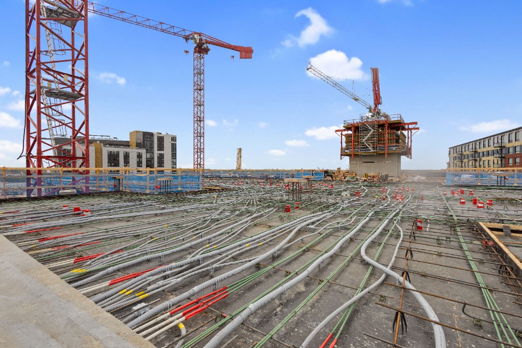 Construction deck with conduit and cranes