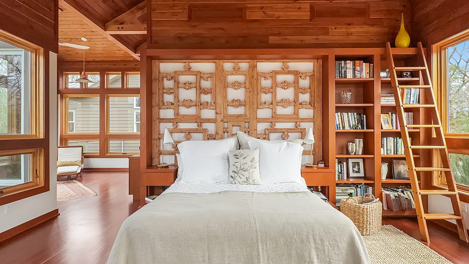 Bedroom with ornate headboard and loft